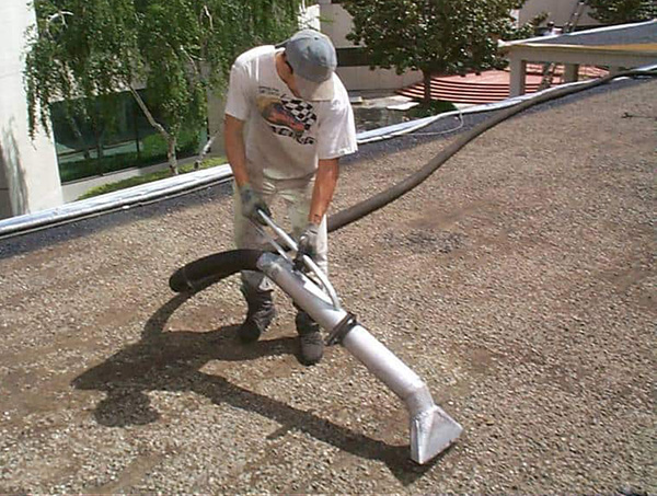 removing loose gravel from commercial roof