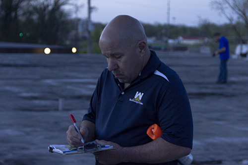 roofer marking wet insulation with infrared camera