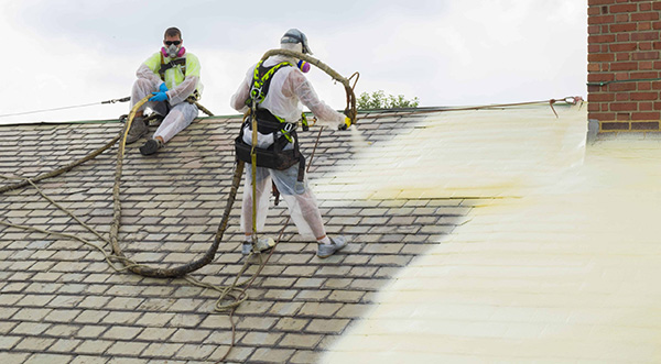 spray foam being installed onto school roof