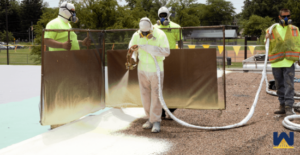 Spraying Foam on roof of school with windscreen