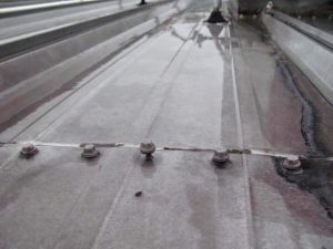 Lifted fasteners on a metal roof that can cause the roof to leak water