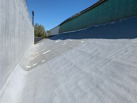 spray foam roof with basecoat of coating