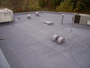 spray foam encapsulates penetrations on an apartment complex roof