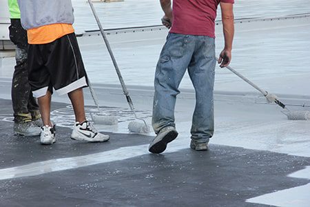 roof coating application after seams have been treated
