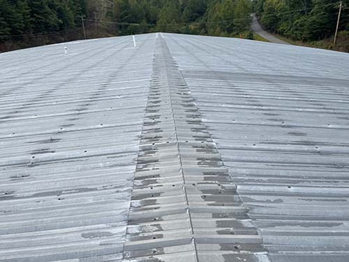 metal roof with many fasteners and water entry opportunities