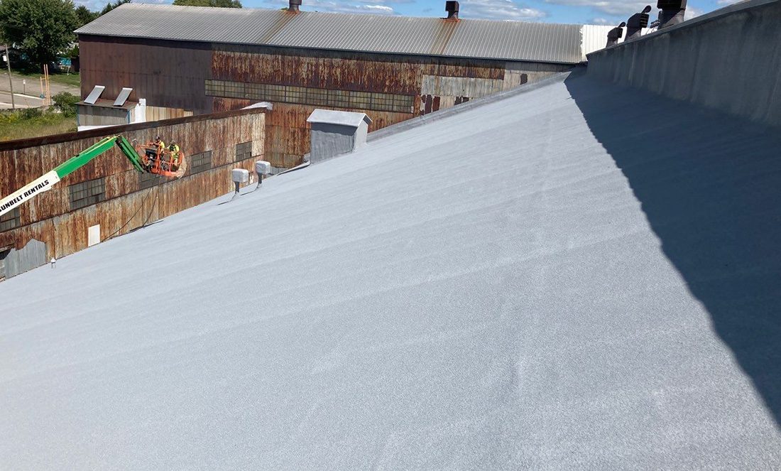 spray foam over steep slope metal roof at Sharpsville Container