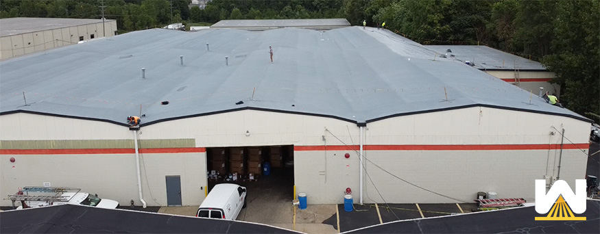 a spray foam roofing system installed on a large warehouse roof