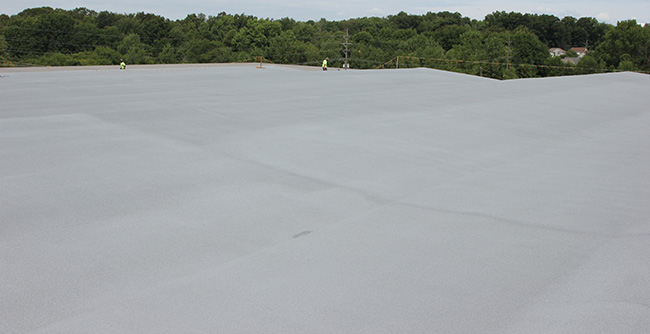 spray foam roofing system installed over existing warehouse roof
