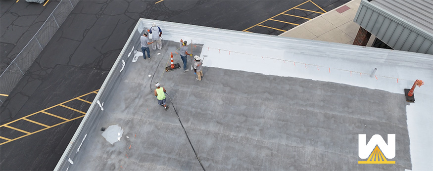 commercial roof coating system being installed