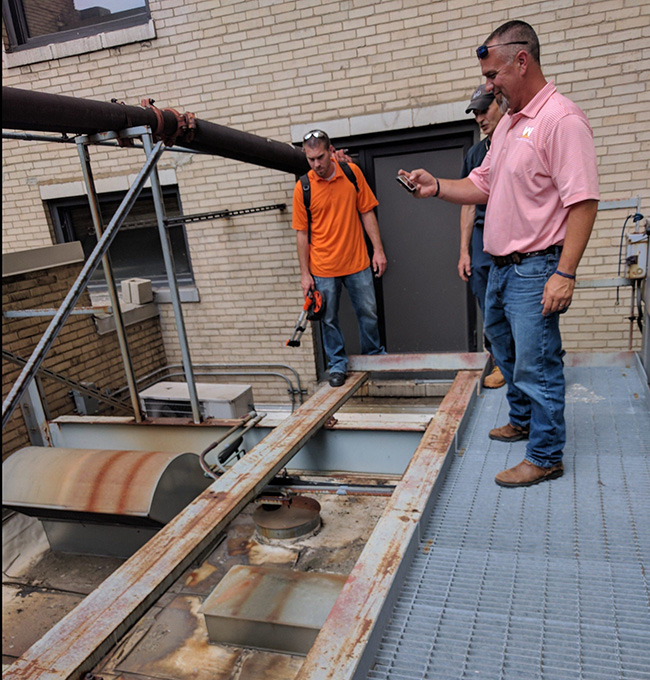 west roofing systems employees doing a roof inspection