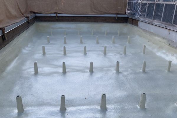 In-progress photo on University Studios roof of spray foam roofing being installed in Cleveland, Ohio