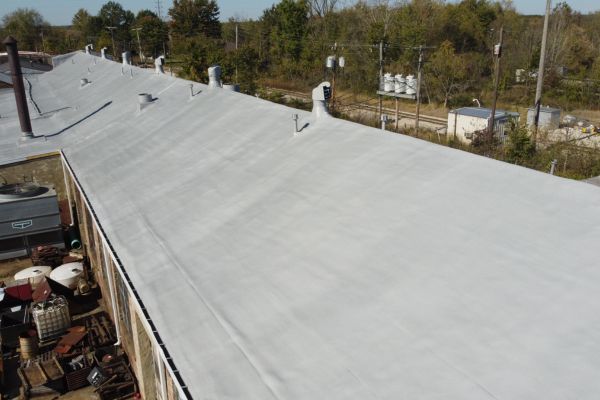 Finished spray foam and coated roof at Spencer Forge & Manufacturing with embedded granules