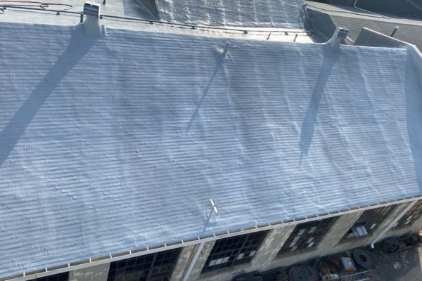 cCompleted spray foam roofing over shingles at Spencer Forge & Manufacturing in Spencer, Ohio