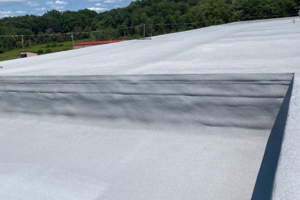Finished section of a spray foam roof in PA. Showing the seamless transition up a vertical wall. It's all one layer.