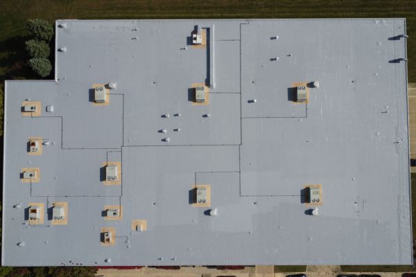 Spray foam applied around roof perimeter at Valtronics