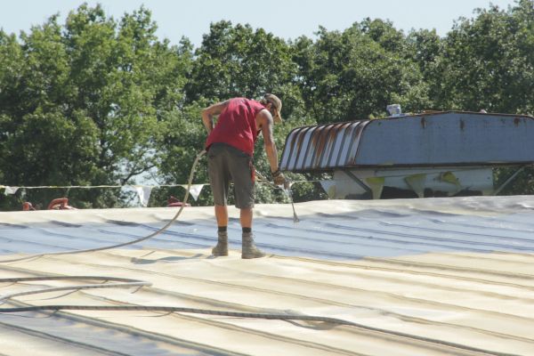 Silicone coating being installed over spray foam at MTD in Willard, Ohio.