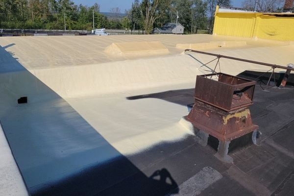 Applying spray polyurethane foam on The Foundry’s historic roof