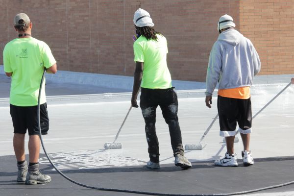 Applying silicone coating on Midview High School roof