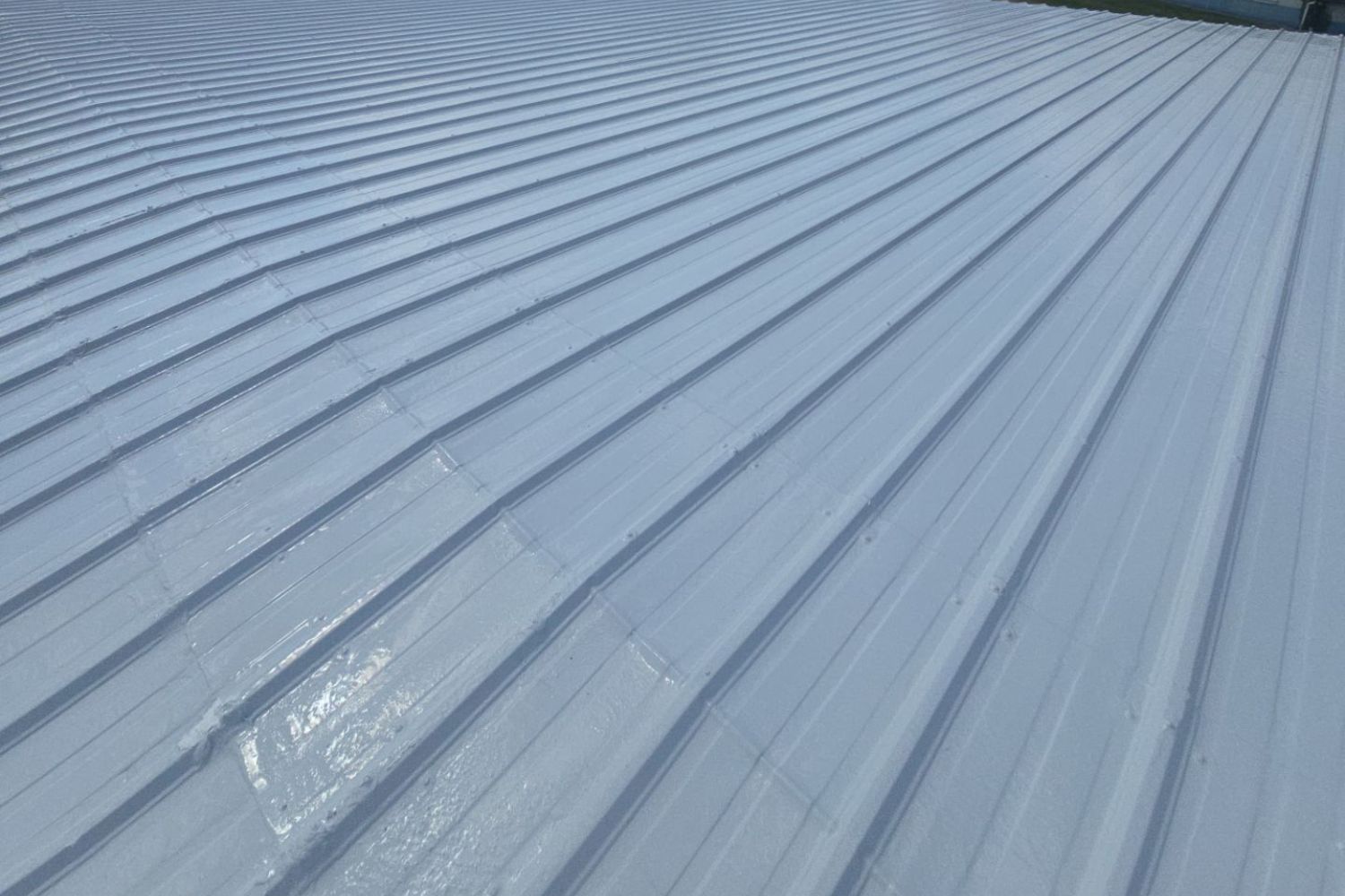 Existing metal roof is restored with a silicone roof coating system