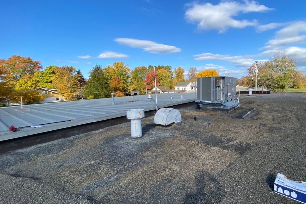 Before image of a commercial gravel built-up roof in Elyria, Ohio that needs repaired