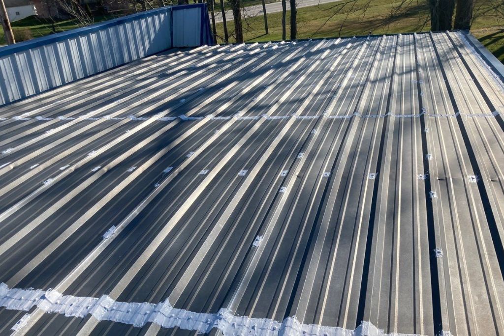 Elyria, Ohio Commercial Metal Roof - Seams and Fasteners are reinforced before coating is installed