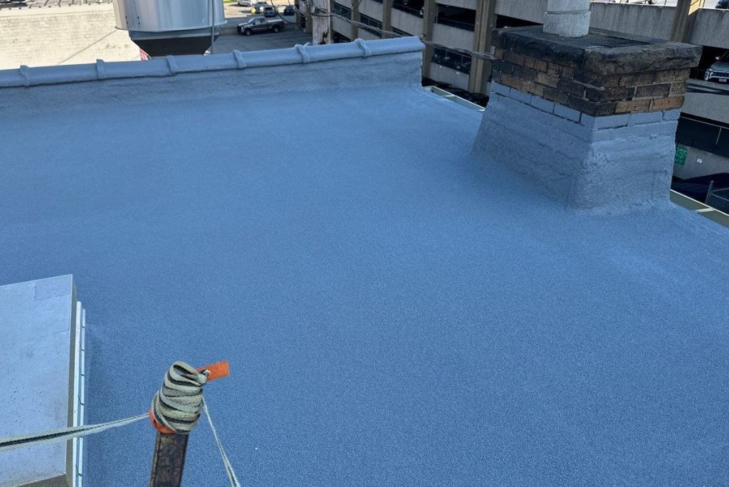 Finished photo of a granulated modified roof being restored with spray foam roofing