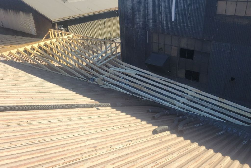 Photo of wood being used on a commercial roof to divert water