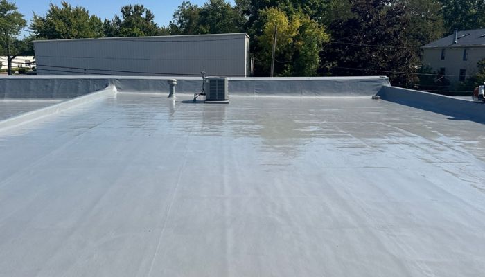 A TPO roof that's been repaired and restored by installing the silicone roof coating system over it